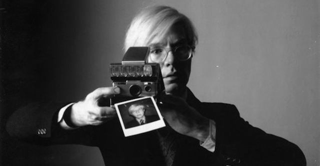 A self-portrait of Andy warhol photography with a Polaroid camera 